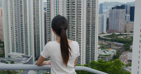 Poster - Woman look at the city in Hong Kong