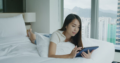 Sticker - Woman use of tablet computer and lying on bed