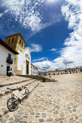 Sticker - VILLA DE LEYVA, COLOMBIA - APRIL 29: Church of Our Lady of the Rosary church and a bike in the main plaza of Villa de Leyva, Colombia on April 29, 2016