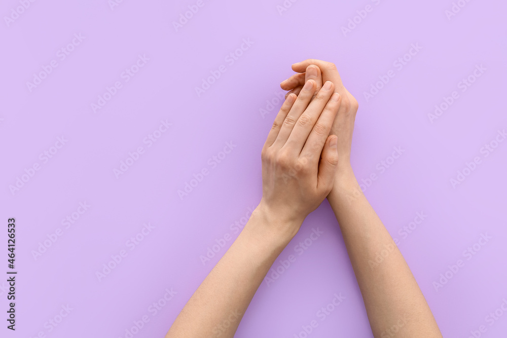 Female hands on color background