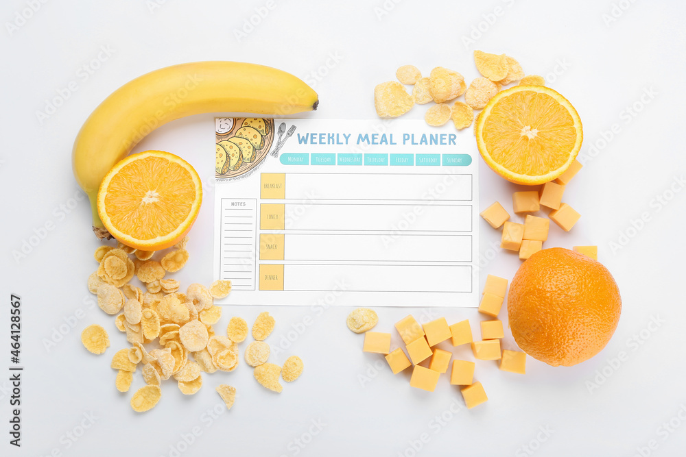 Meal plan with cheese, fruits and corn flakes on white background