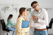 © Pixel-Shot - Workers gossiping about their colleague in office