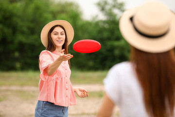 Sticker - Beautiful young women playing frisbee outdoors