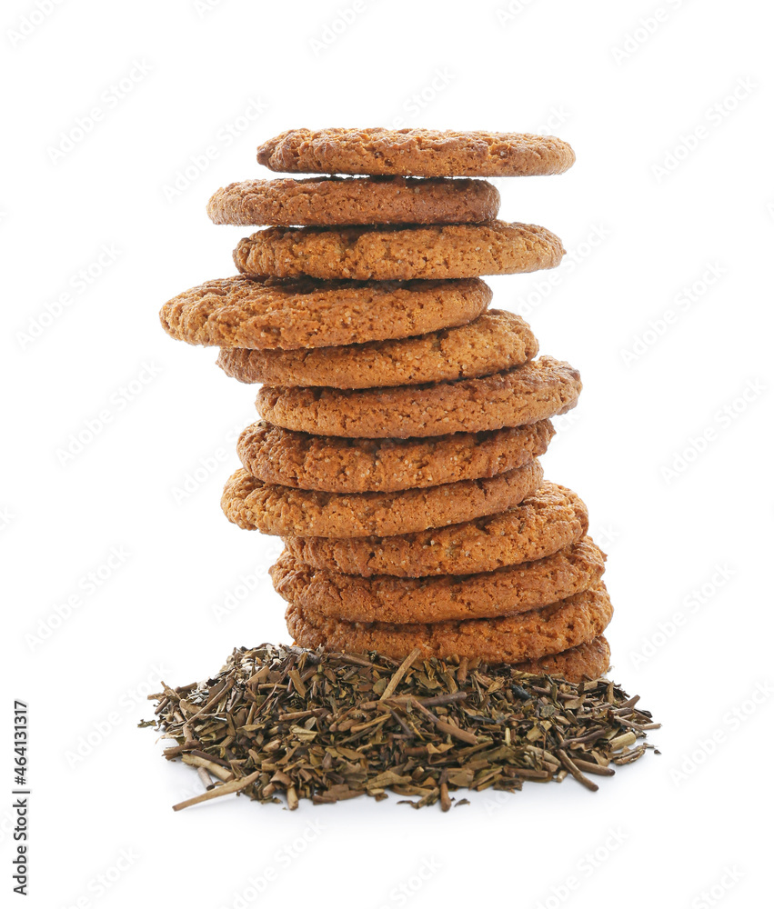 Tasty hojicha cookies and dry leaves on white background