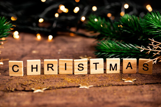 Christmas lettering on wooden table, atmospheric festive Christmas card