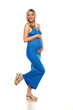 Young happy pregnant woman posing in a long blue dress