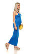 Young happy pregnant woman walking in a long blue dress