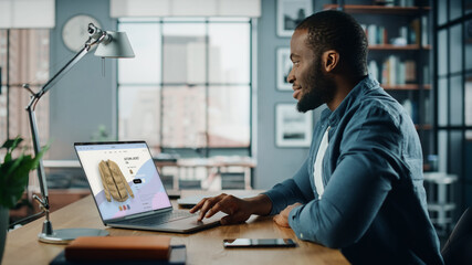 Aufkleber - Handsome Black African American Man is Using Laptop Computer with Clothing Online Web Store to Choose and Buy Clothes for New Fresh Look. Beautiful Man Surfing the Internet at Home Living Room.