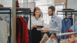 © Gorodenkoff - Clothing Store: Businesswoman Uses Tablet Computer, Talks to Visual Merchandising Specialist, Collaborate To Create Stylish Collection. Small Business Fashion Shop Sales Manager Talks to Designer