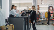 © Gorodenkoff - Clothing Store Checkout Cashier Counter: Beautiful Young Woman Buys Blouse from Friendly Retail Sales assistant, Paying with Contactless Credit Card. Fashion Shop with of Designer Brands.