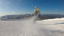 SLOW MOTION: A Girl On A Snowboard Rides In The Morning On Fresh Corduroy On A Ski Track. Second-person View, Camera Pursuit. The Concept Of Active Recreation In Winter. 2k Prores