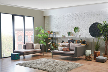 Wall Mural - Modern living room sofa and working wood table style in the room, brick and brown classic wall background, grey bookshelf and accessory, laptop computer.