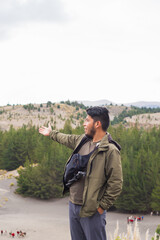 Poster - Vertical shot of the young man outdoors, enjoying the fresh air and beautiful view.