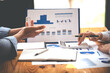 © Daenin - Team work with business analytic price chart on the table at the conference room.