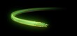 Light particles in motion. Green and yellow circular path. Black background. 