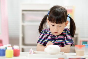 Wall Mural - young girl decorating hand made craft for homeschooling