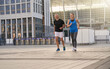 © Kostiantyn - Active middle aged couple, man and woman running together in the city while training outdoors