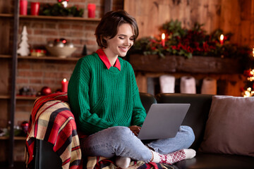 Poster - Photo of charming pretty young lady wear green pullover smiling working modern gadget sitting sofa indoors house home room