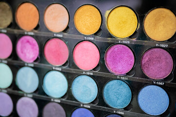 Wall Mural - Colorful eyeshadow pallet for make up in cosmetic store - close up view. Makeup, beauty, fashion and glamour concept