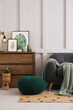 © New Africa - Stylish living room interior with knitted pouf, sofa and wooden chest of drawers