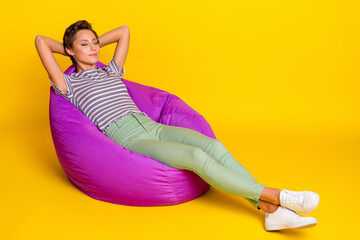 Poster - Full size photo of sleepy young lady sit on bag wear t-shirt jeans sneakers isolated on yellow background