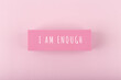 I am enough concept. Hand written text on bright pink background