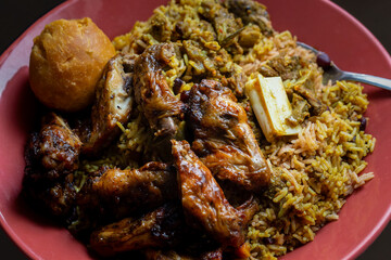 Wall Mural - Traditional Jamaican jerk chicken wings, curried goat and fried dumpling with rice and peas