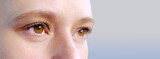 close up part of the woman's face, girl 20-29 years old, human eye looking to the side, the concept of surveillance, peeping, tracking, vision examination, cosmetic procedures