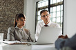 © Goran - Businessman talking to his colleague during a meeting in the office