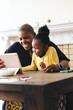 © Lisa Weatherbee - Happy mother using digital tablet with daughter at table