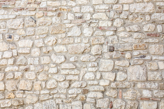 stone antique old wall as a background or texture. vintage background of a fortress wall in loft and
