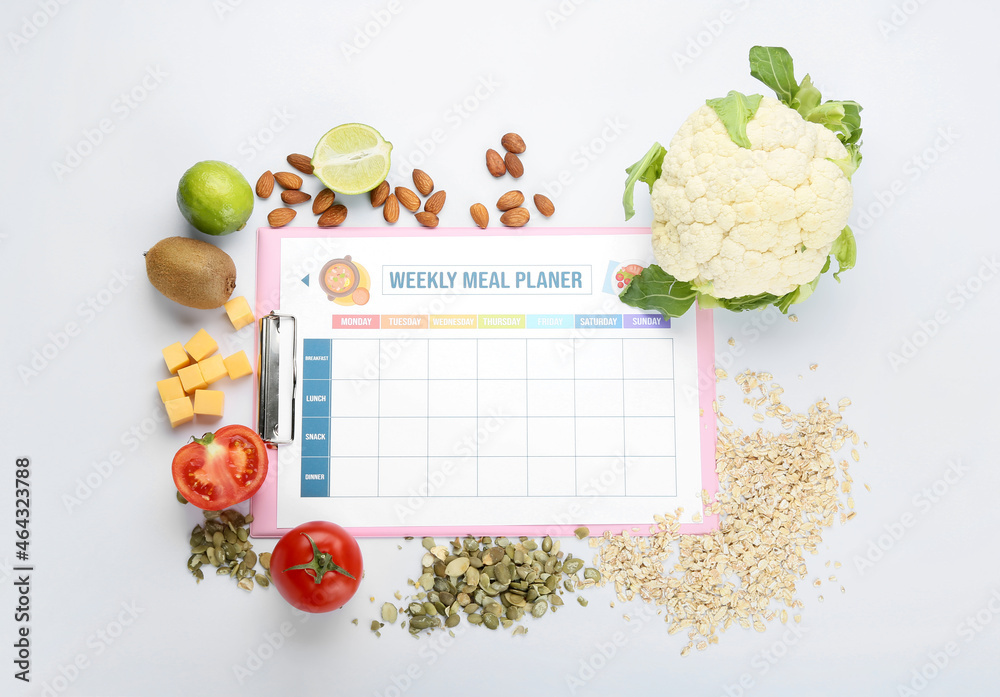 Healthy products with meal plan on white background