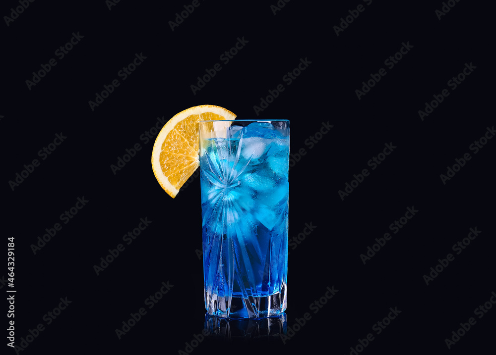 Glass of Blue Lagoon cocktail on dark background