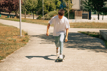 Poster - young teenager boy on the street skating with skateboard