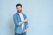 Smiling Man Freelancer Pointing Right With Index Finger And Looking At Camera