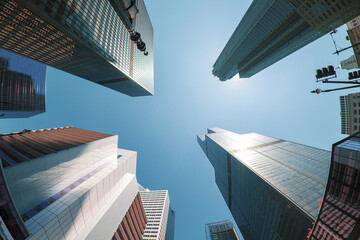 Sticker - Low angle shot of a tall skyscraper and a blue sky