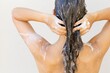 A sexy woman washing and shampooing her hair. Personal hygiene and beauty.