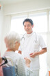 © amanaimages - 介護老人を診察する医者