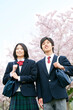 © amanaimages - 桜と男女学生2人