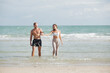 © nikomsolftwaer - young couple walking at each other at beach. Romantic couple walking on sea, enjoying life and each other at honeymoon vacation.