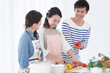 © amanaimages - 料理をする家族3人