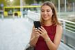 © zigres - Attractive girl using phone outdoors