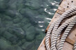 Rolled up white ropes on a boating dock yard in Spain