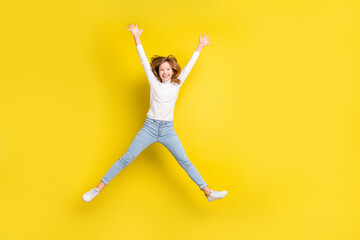 Poster - Full length photo of young cheerful girl happy positive smile have fun jump up isolated over yellow color background