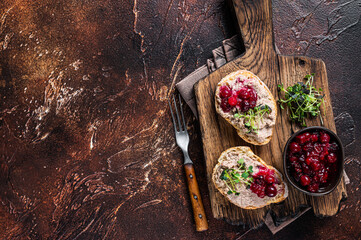 Wall Mural - Duck rillettes pate toasts with sprouts on a wooden board. Dark background. Top View.  Copy space