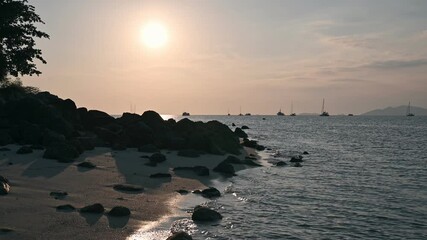 Wall Mural - Sunset over tropical sea and wave splashing on coastline at lipe island