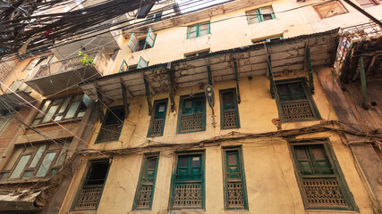 Wall Mural - Old traditional wooden windows a in small street in Kathmandu, Nepal