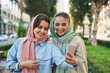 © Yakobchuk Olena - Islamic female friends making selfie on smartphone while staying at the city