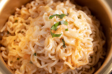 spicy instant noodle in a golden pot with mozzarella cheese