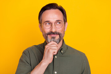 Canvas Print - Photo of mature man happy positive smile hand touch chin think wonder look empty space isolated over yellow color background